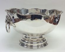 A large silver rose bowl with lion mask handles an