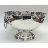 A large silver rose bowl with lion mask handles an