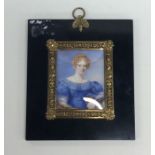 A rectangular painted miniature of a lady in gilt