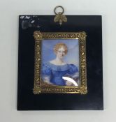 A rectangular painted miniature of a lady in gilt