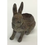 A novelty hatpin stand in the form of a hare with