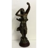 A spelter model of a lady with outstretched arms.