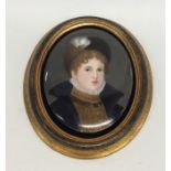 A large oval porcelain miniature of a lady with ha