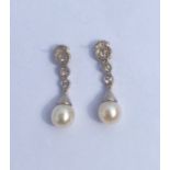 An important pair of pearl and diamond cocktail ea