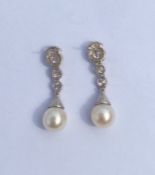 An important pair of pearl and diamond cocktail ea