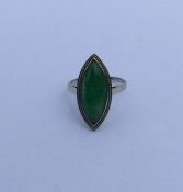 A large jade marquise shaped ring in white gold cl