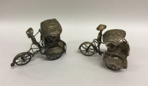 A pair of Continental silver rickshaws. Approx. 13