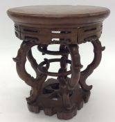 A carved Oriental hardwood vase stand. Approx. 22