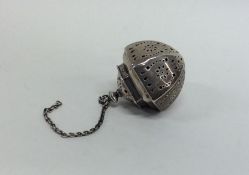 An Edwardian silver tea infuser with pierced body.