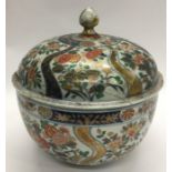 A massive Imari bowl and cover decorated in bright