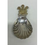 An unusual cast silver and silver gilt caddy spoon