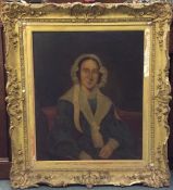 A large gilt framed portrait of a lady. Oil on can