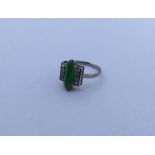 A diamond and jade three row ring in white gold. A