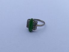 A diamond and jade three row ring in white gold. A
