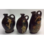A group of three Royal Doulton jugs decorated in b