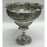 A large tall Indian silver sweet dish decorated wi