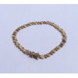 A small 9 carat diamond set line bracelet with conc