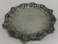 A circular silver pie crust waiter. London. By MJ. Approx. 22 cms