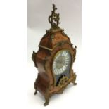 A French mantle clock decorated with ormolu mounts