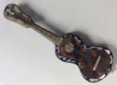 A small tortoiseshell and MOP guitar. Est. £25 - £