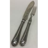A pair of silver bead pattern fish servers attract