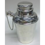 A dinky silver cocktail shaker with lift-off cover
