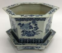 A blue and white ground Chinese planter on matchin