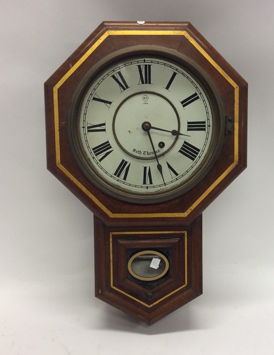 A mahogany cased clock with white enamelled dial.