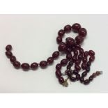 Two strings of tapering red amber beads. Approx. 6