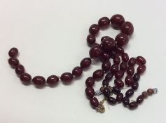 Two strings of tapering red amber beads. Approx. 6