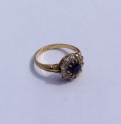 A good sapphire and diamond circular cluster ring