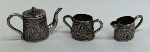An unusual miniature Japanese silver tea set with