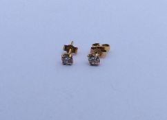 A pair of small diamond single stone ear studs. Ap