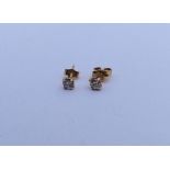 A pair of small diamond single stone ear studs. Ap