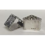 A pair of stylish silver napkin rings decorated wi