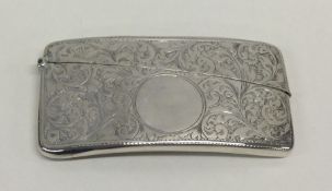 A small silver card case decorated with flowers an