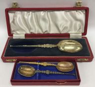 Two boxed silver gilt apostle top spoons decorated