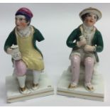 A pair of early Staffordshire figures of gentlemen