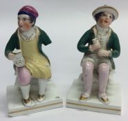 A pair of early Staffordshire figures of gentlemen