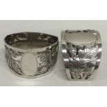 A pair of attractive silver scroll decorated napki