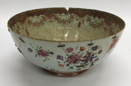 A Chinese fruit bowl decorated with flowers and le