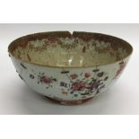 A Chinese fruit bowl decorated with flowers and le