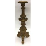 A tall gilt pedestal decorated with scrolls and fl