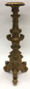 A tall gilt pedestal decorated with scrolls and fl