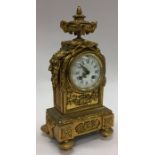 A French brass mantle clock attractively decorated