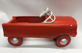 A novelty child's toy in the form of a ride-on car