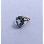 An aquamarine and diamond pear shaped cluster ring