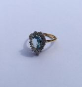 An aquamarine and diamond pear shaped cluster ring