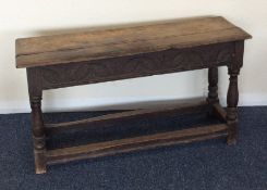 A small oak joint stool with carved front and stre