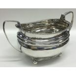 A Georgian silver sugar bowl on four ball feet. Lo